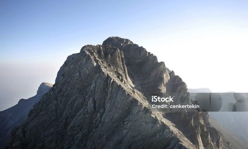 "Summit of Mount Olympus from Mount Skala. Mount Olympus is highest mountain in Greece at 2917 meters. Peak name is Mytikas. Mount Olympus is the home of the Twelve Olympians, the principal gods in the Greek pantheon."